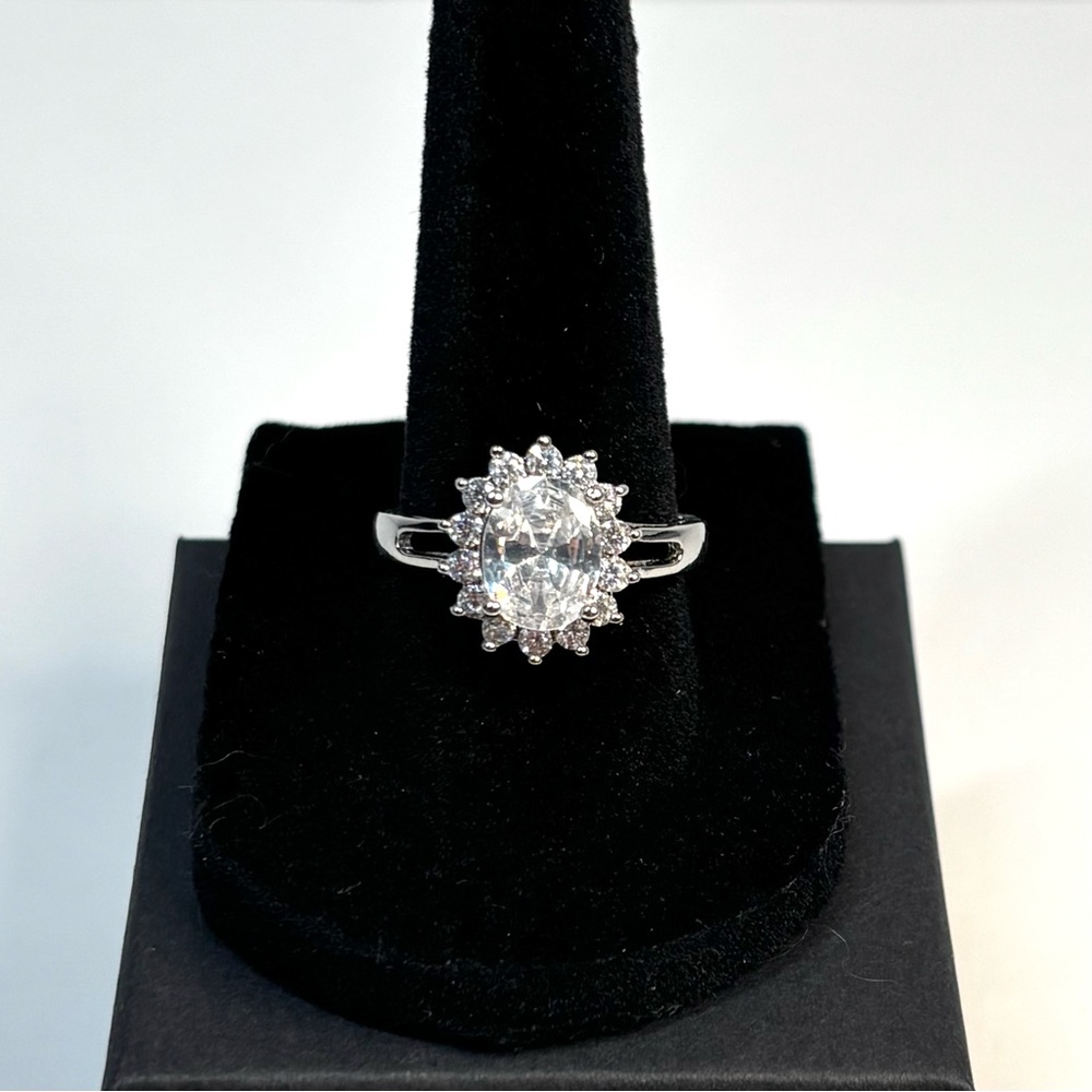 18k white gold-plated ring featuring a white oval CZ stone with halo